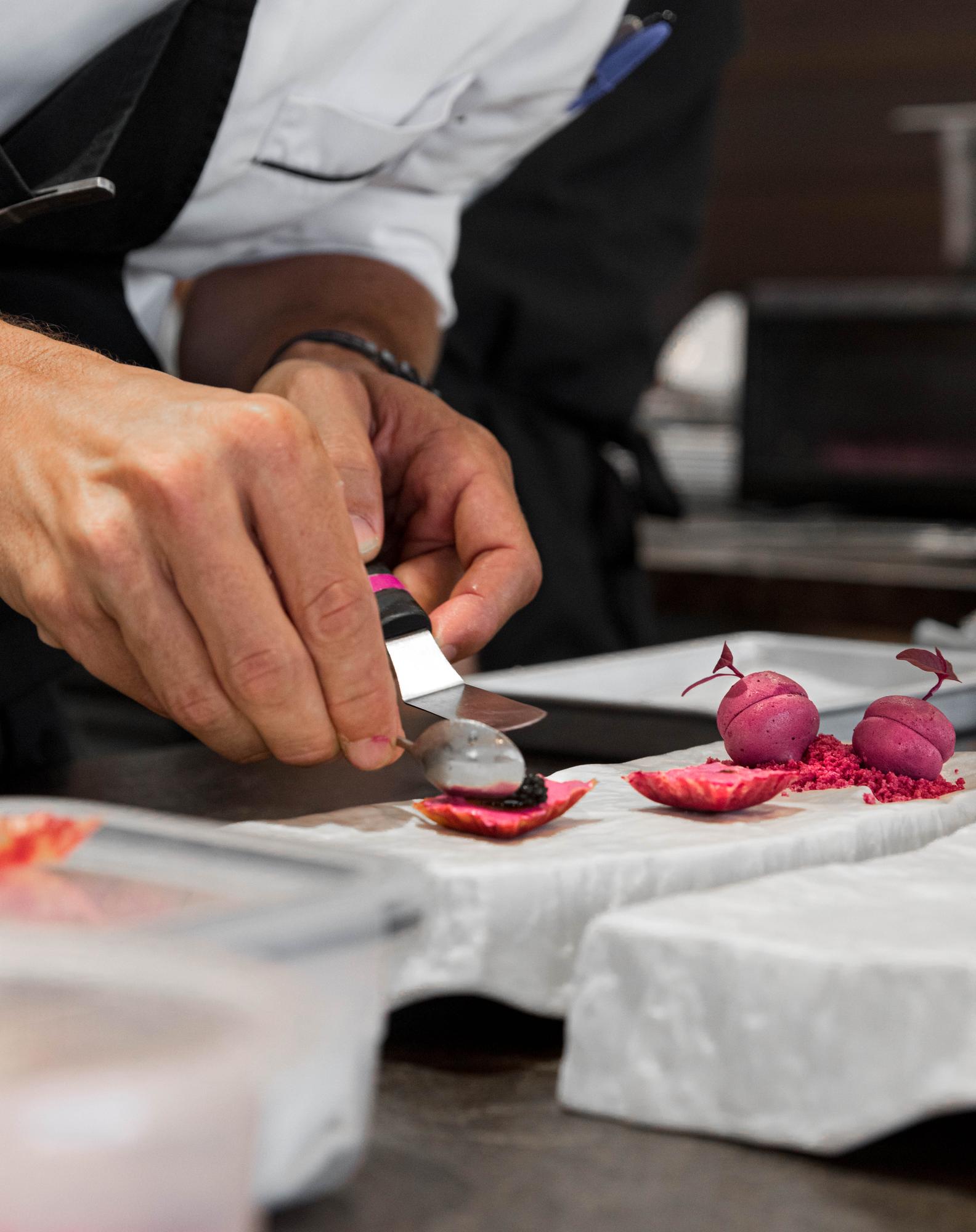 Chef demonstrating knife technique in studio kitchen